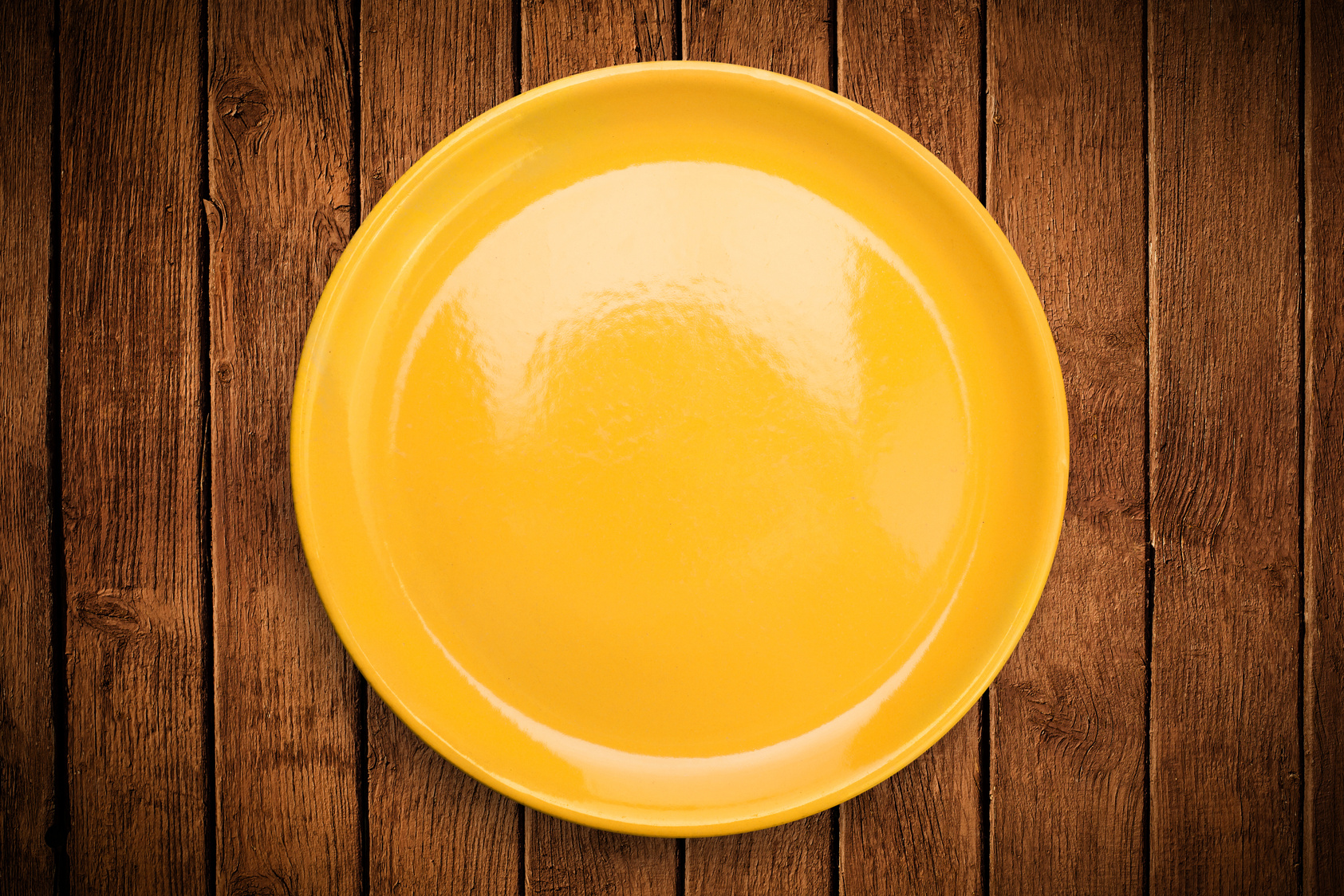 Colorful empty plate on grungy background table